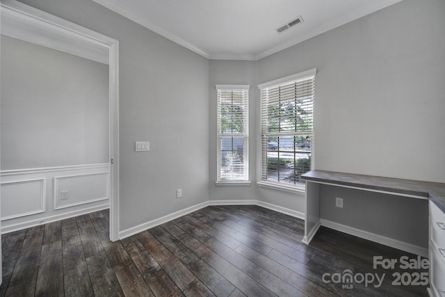 empty room with crown molding and dark hardwood / wood-style flooring