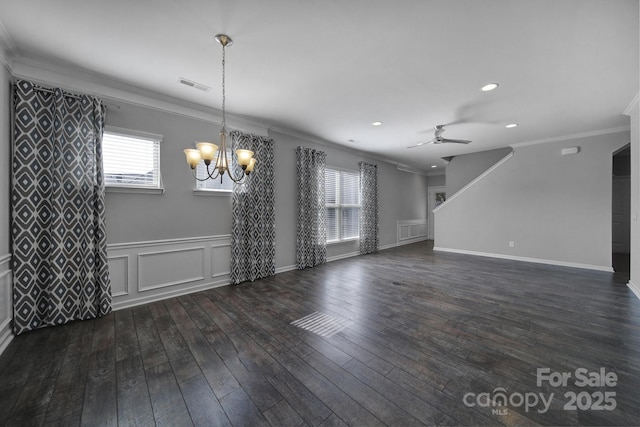 interior space with dark wood-type flooring, ornamental molding, and ceiling fan with notable chandelier