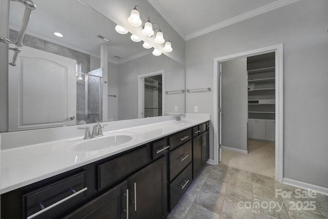 bathroom with a shower with door, vanity, and crown molding