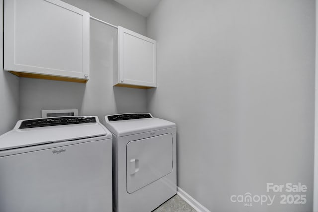 laundry room with cabinets and washing machine and dryer