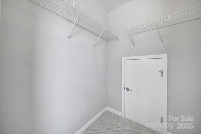 walk in closet featuring tile patterned flooring