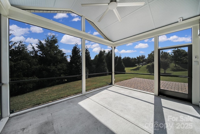 unfurnished sunroom with vaulted ceiling and ceiling fan