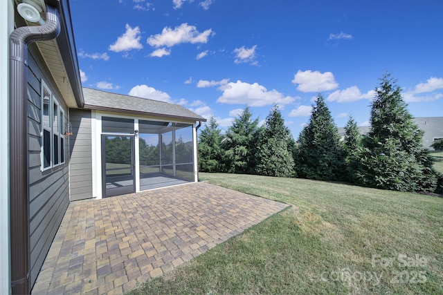 view of yard featuring a sunroom and a patio area