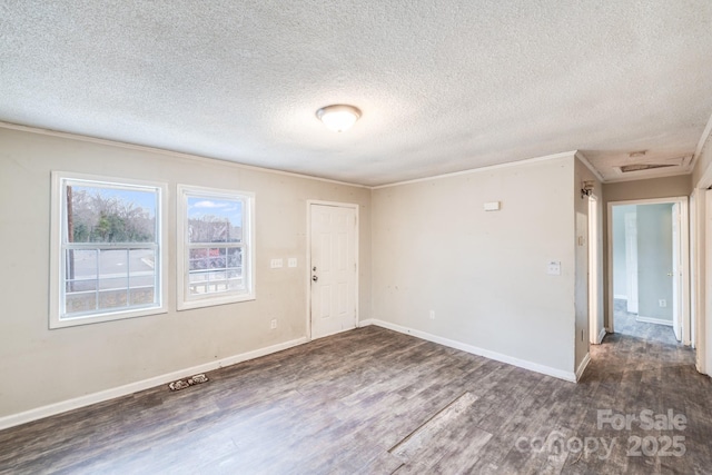 unfurnished room with ornamental molding, dark hardwood / wood-style floors, and a textured ceiling