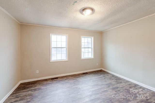 unfurnished room with crown molding, dark hardwood / wood-style floors, and a textured ceiling