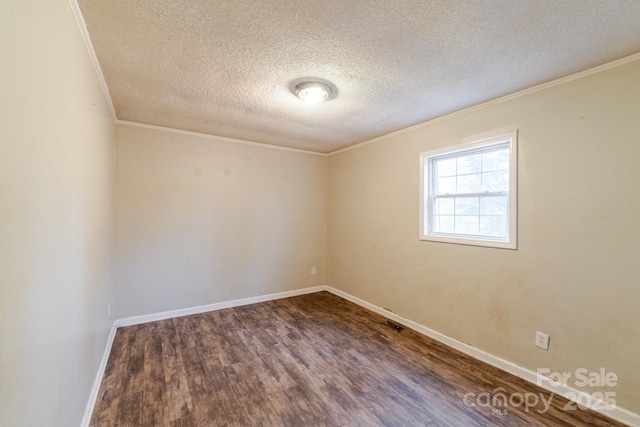 empty room with ornamental molding, a textured ceiling, and dark hardwood / wood-style flooring