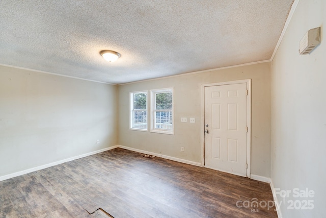 unfurnished room featuring crown molding, dark hardwood / wood-style floors, and a textured ceiling