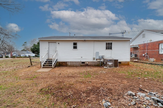 rear view of property featuring central AC unit