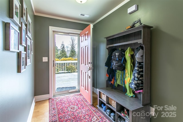 mudroom with baseboards, visible vents, wood finished floors, and ornamental molding