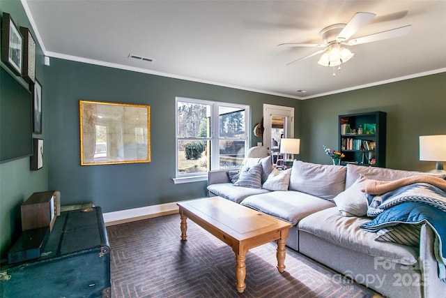 living room featuring baseboards, visible vents, ceiling fan, and crown molding