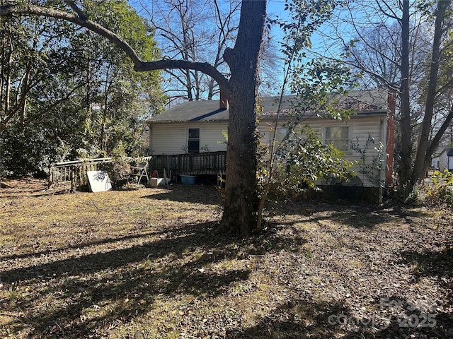 view of yard featuring a wooden deck