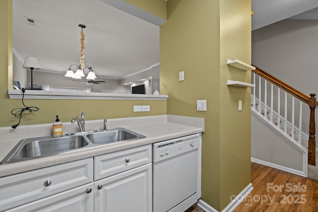 kitchen with sink, white cabinetry, hanging light fixtures, dishwasher, and hardwood / wood-style flooring