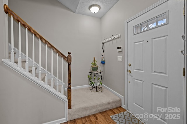 entryway featuring a textured ceiling and light wood-type flooring