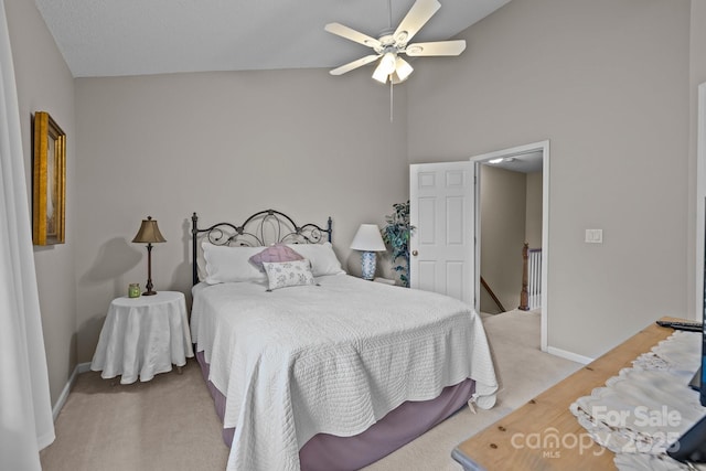 bedroom featuring high vaulted ceiling, light colored carpet, and ceiling fan