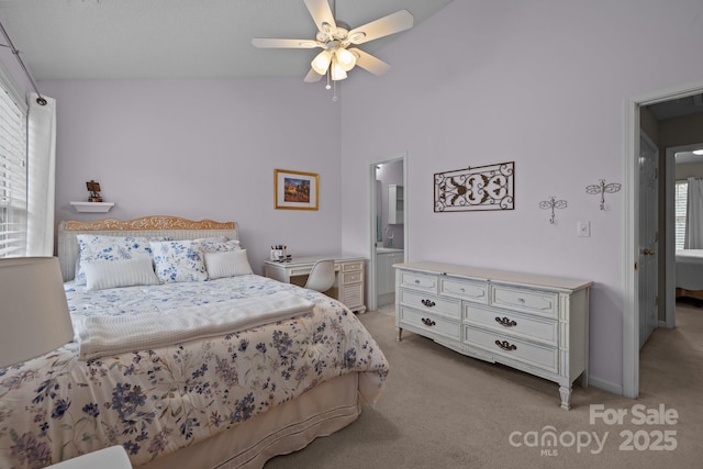 bedroom with light carpet, ensuite bath, lofted ceiling, and ceiling fan