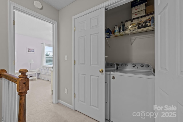 laundry room featuring light carpet and independent washer and dryer