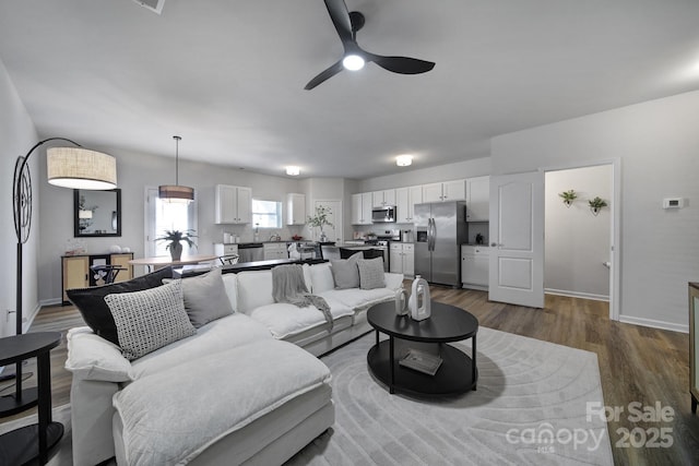 living room featuring hardwood / wood-style flooring and ceiling fan