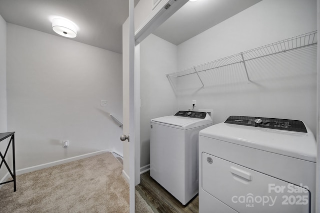 clothes washing area with washer and clothes dryer and dark colored carpet