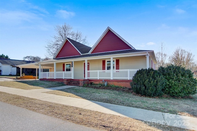 farmhouse-style home with a porch and a front lawn