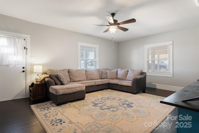 living room featuring dark hardwood / wood-style flooring and ceiling fan