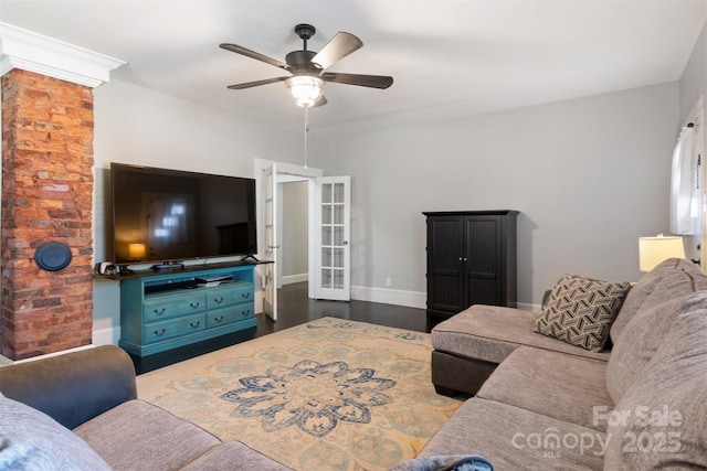 living room featuring dark hardwood / wood-style floors, ceiling fan, and french doors