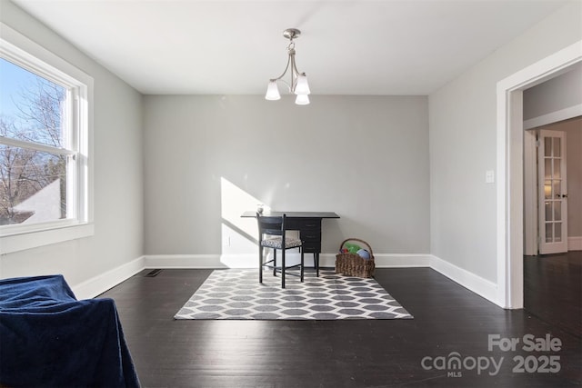 interior space with dark hardwood / wood-style floors and a notable chandelier