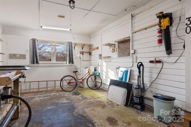 interior space with concrete floors and wooden walls