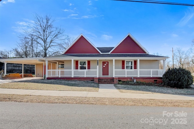 farmhouse featuring a carport and covered porch