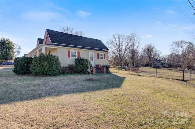 view of side of home with a yard