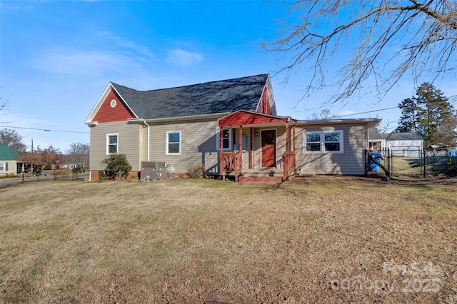 view of front of property with central AC and a front lawn