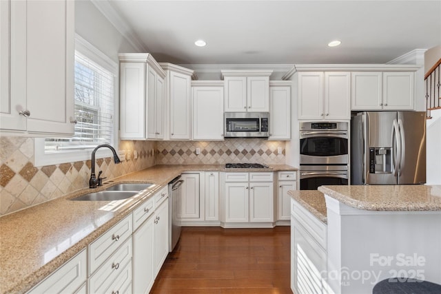 kitchen featuring light stone countertops, appliances with stainless steel finishes, sink, and white cabinets