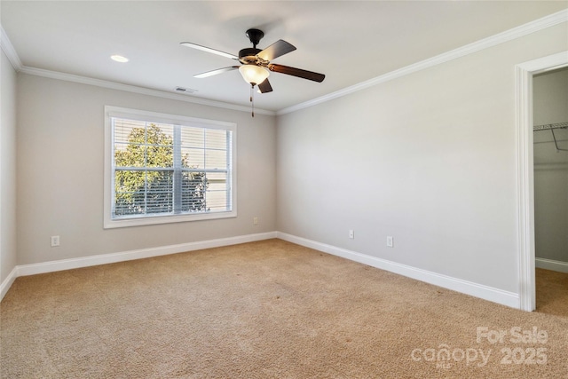 carpeted spare room featuring ornamental molding and ceiling fan