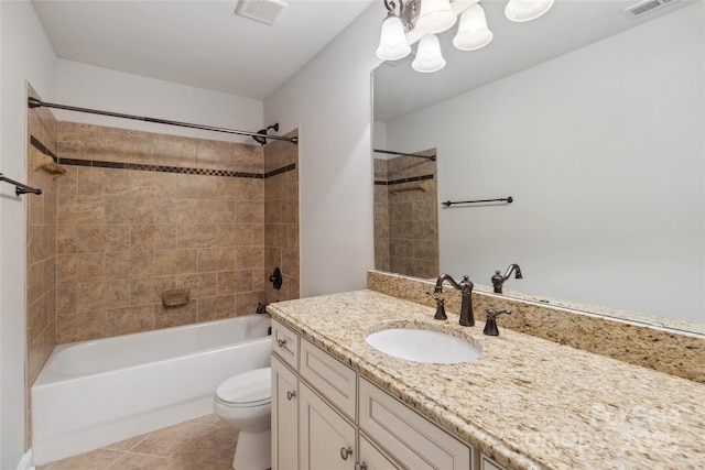 full bathroom with tiled shower / bath combo, vanity, tile patterned floors, and toilet