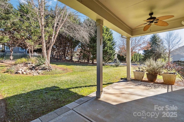 view of yard with ceiling fan and a patio area