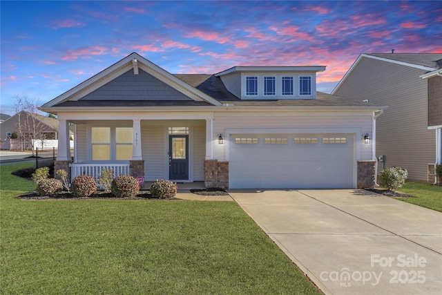 craftsman-style home with a garage, a yard, and covered porch