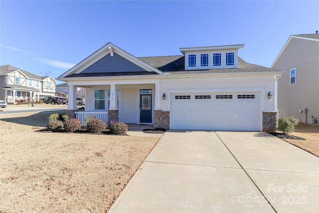 view of front of property featuring a garage and covered porch