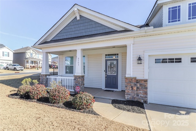 view of front facade with a garage and covered porch