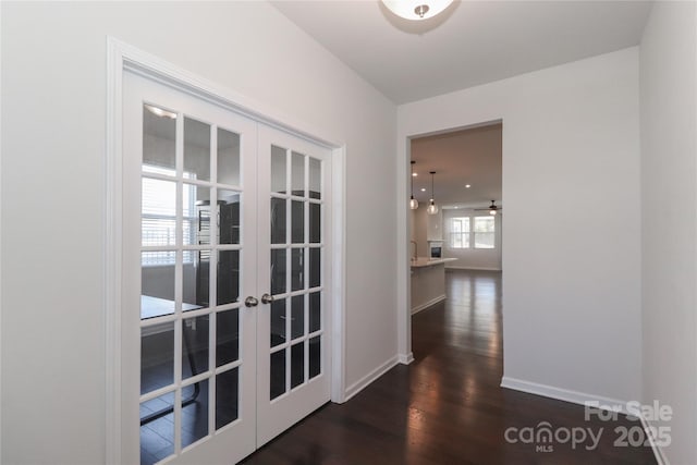 corridor with french doors and dark wood-type flooring