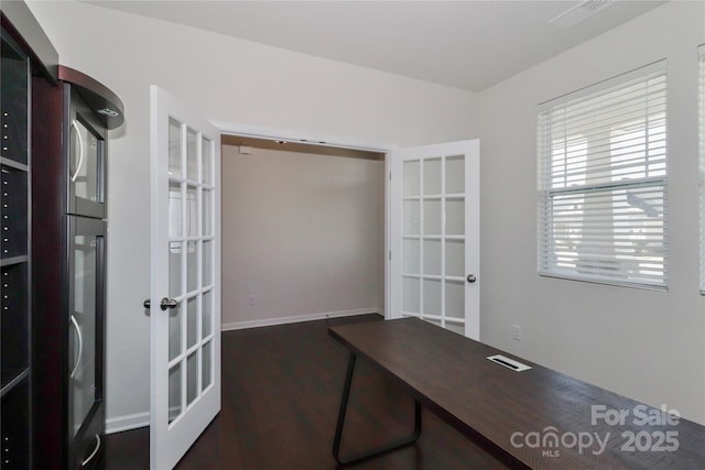 unfurnished office featuring dark hardwood / wood-style flooring and french doors