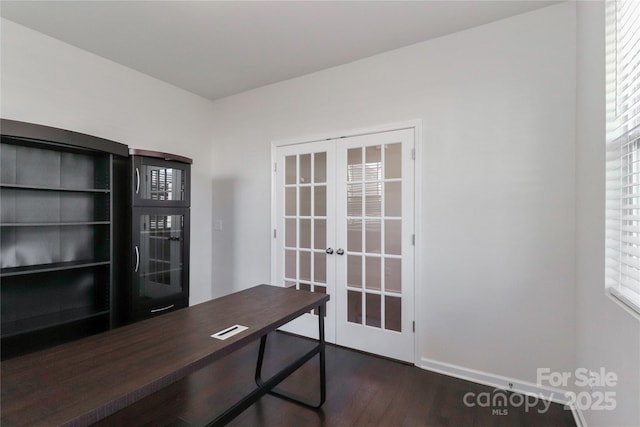 home office with french doors and dark wood-type flooring