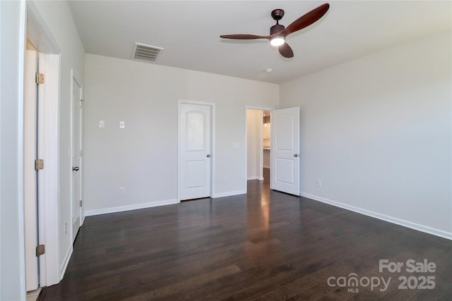 unfurnished bedroom featuring ceiling fan and dark hardwood / wood-style flooring