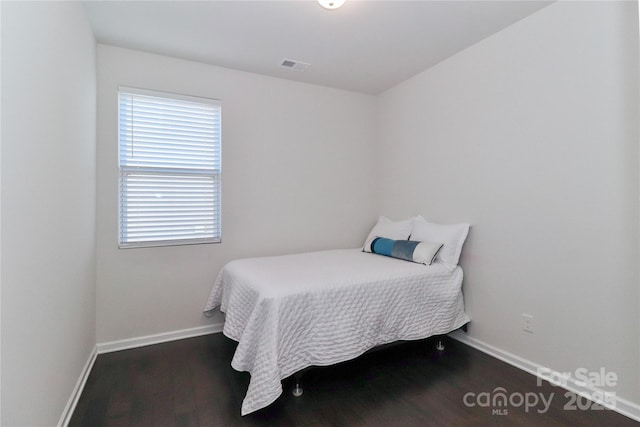 bedroom featuring dark hardwood / wood-style flooring