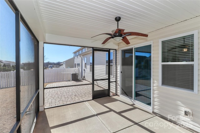 unfurnished sunroom with ceiling fan