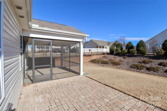 view of patio featuring a sunroom