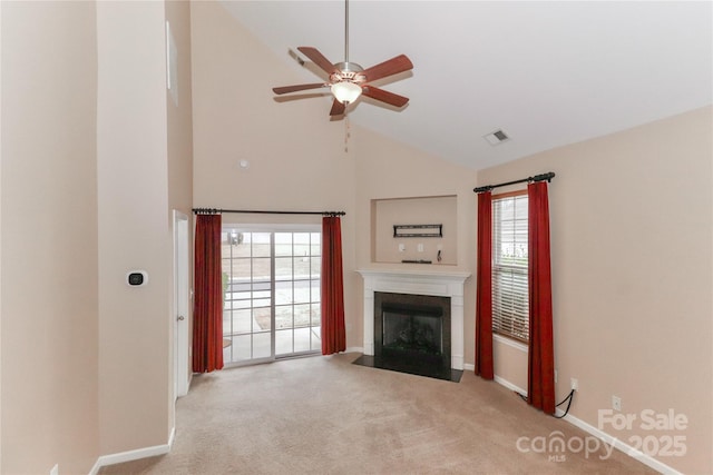 unfurnished living room featuring high vaulted ceiling, light colored carpet, and ceiling fan