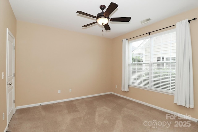 unfurnished room featuring light carpet and ceiling fan