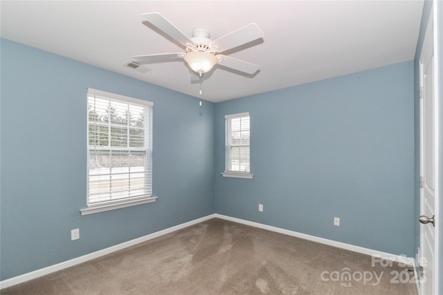 carpeted empty room featuring ceiling fan