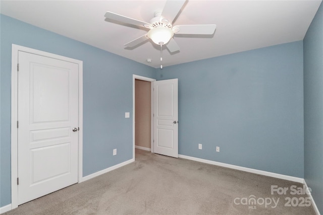 unfurnished bedroom featuring light colored carpet and ceiling fan