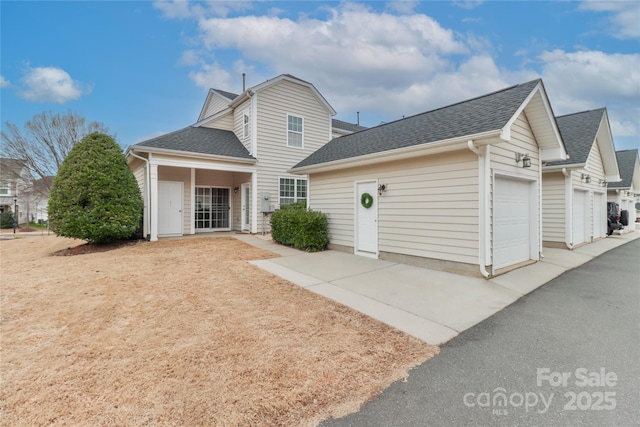 back of house featuring a garage