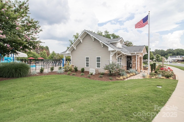 view of property exterior with a fenced in pool and a yard